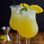 two glasses in cocktails with ice pineapple jalapeño
