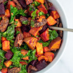 Sweet Potato Beet Kale Salad in white serving bowl with spoon