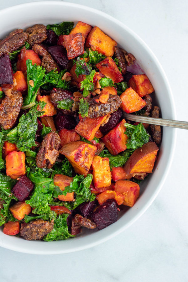 Sweet Potato Beet Kale Salad in white serving bowl with spoon